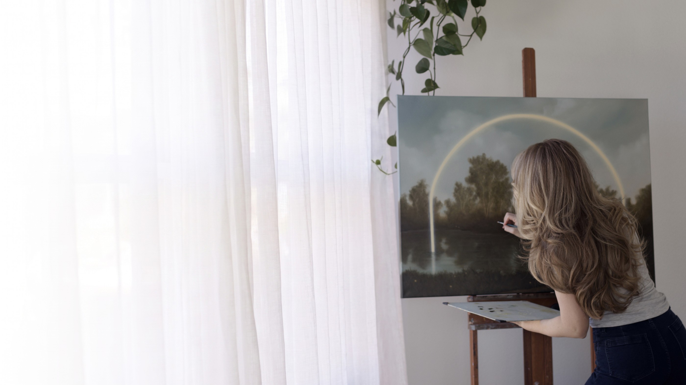 Savannah Morgan painting Firefly Lake at her easel